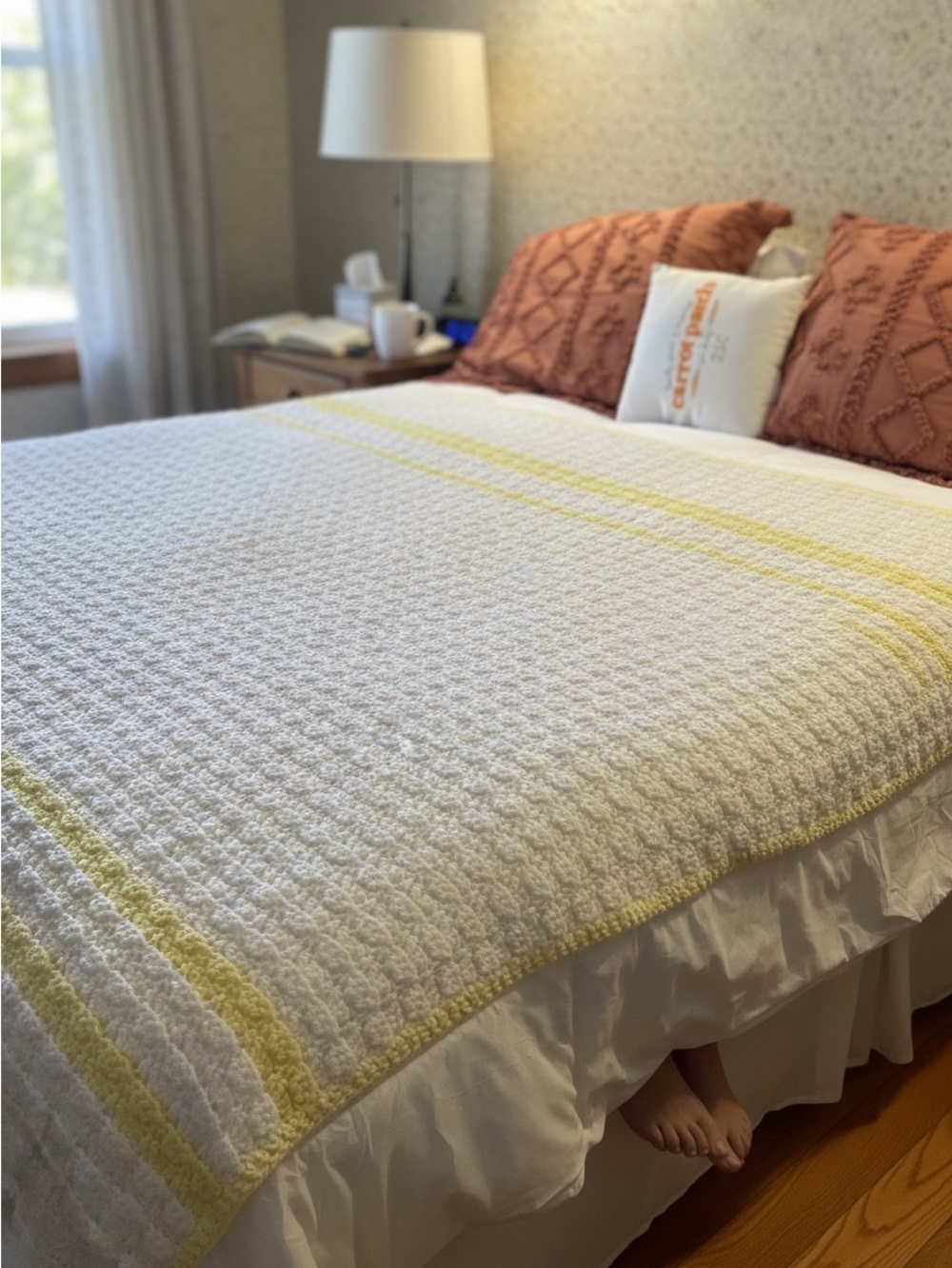 Crocheted bed cover, handmade, light and airy, shown on a queen size bed